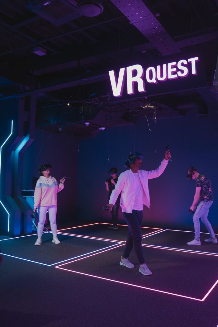 Mastering the First Impression: Your intriguing post title goes here Four people immerse in virtual reality gaming at VR Quest center.